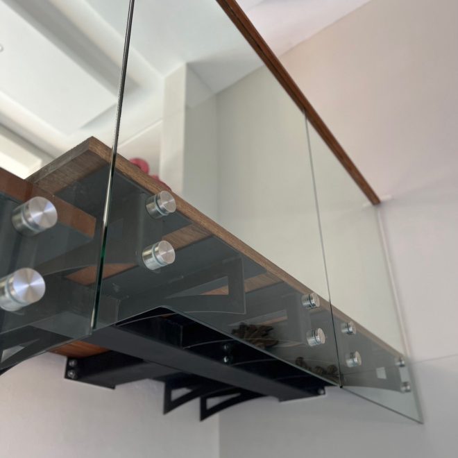 Single stringer Staircase Meranti wood threads, clear glass balustrade finished with elegant Meranti wood infills - Residential